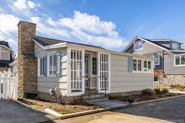 View of front of property with entry steps and a chimney