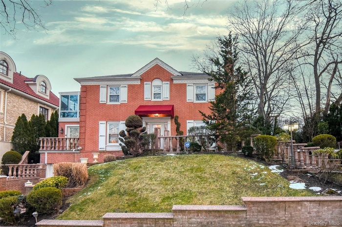 View of front of property featuring brick siding and a front lawn