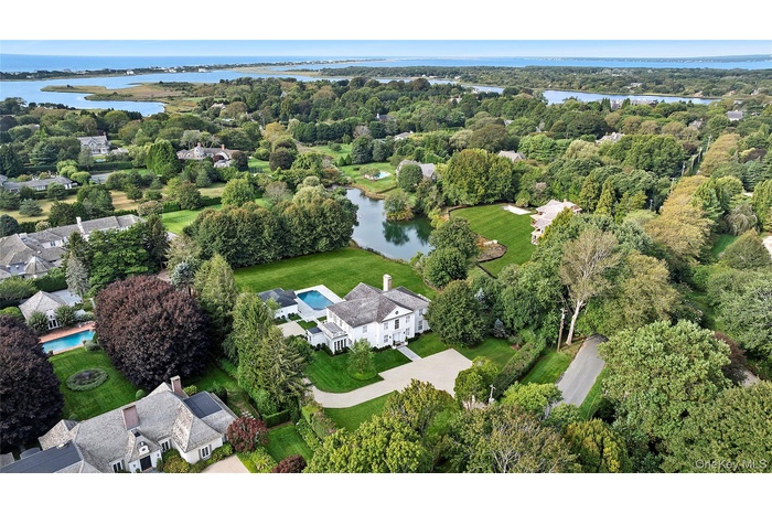 Aerial overview of property's location featuring a large body of water and nearby suburban area