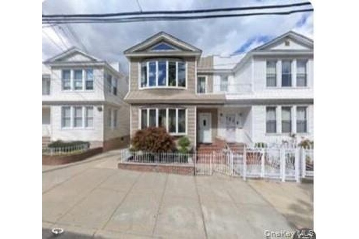 View of front of house with a fenced front yard and covered porch