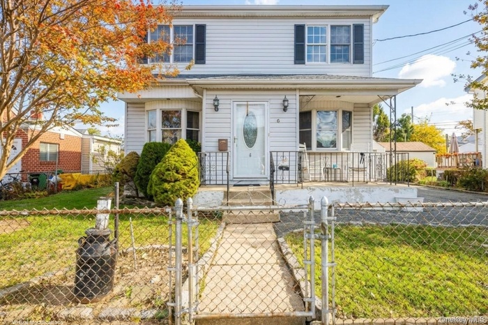 View of front of house featuring a gate and a fenced front yard