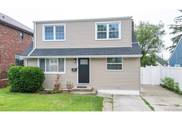 View of front of house with a shingled roof