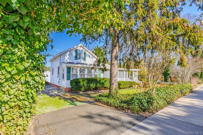 View of front facade with a sunroom