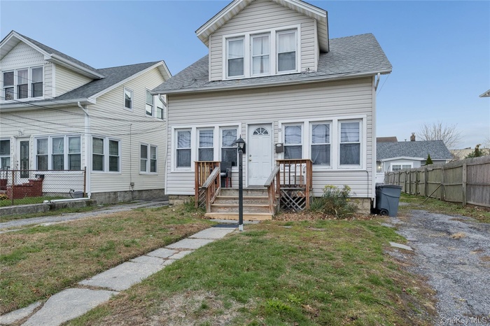 View of front of home featuring roof with shingles