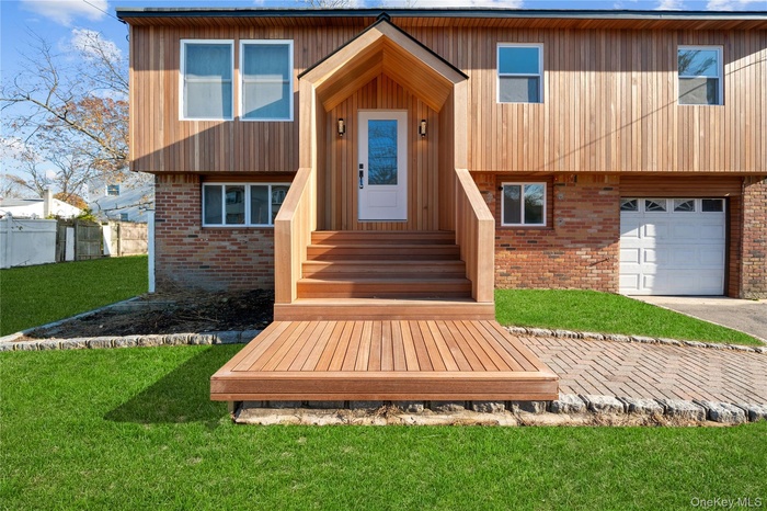 View of front of house with brick siding and a garage