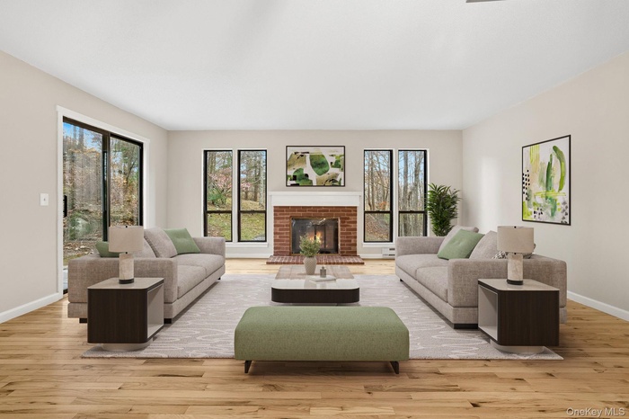 Living Room  featuring a fireplace and light wood finished floors **virtually staged**