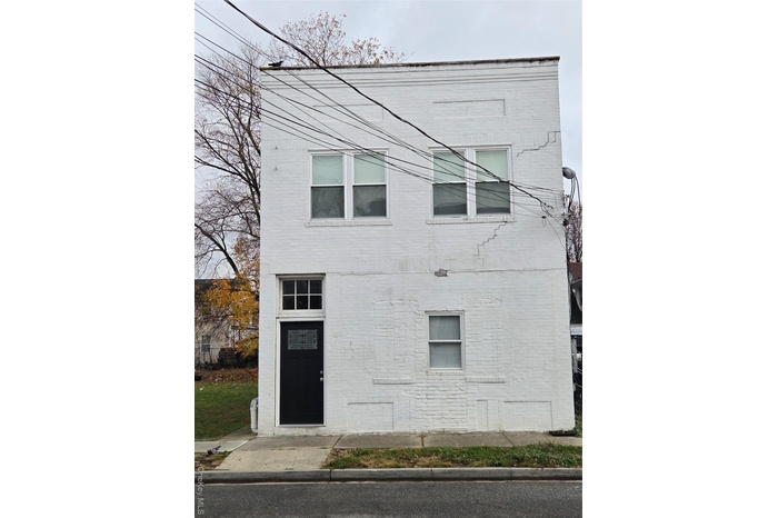 View of property exterior featuring brick siding