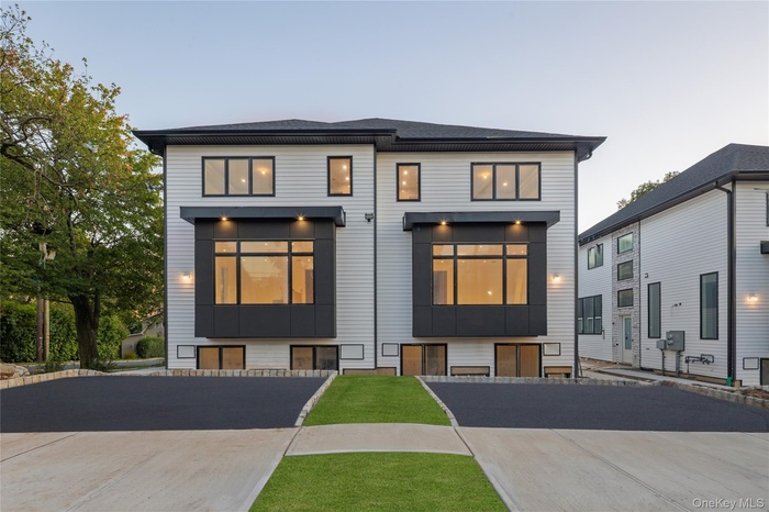 Contemporary home featuring roof with shingles