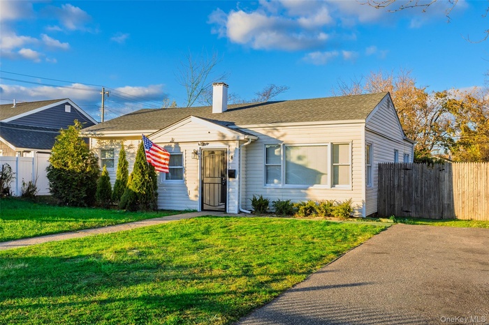 Bungalow-style home with a chimney and roof with shingles