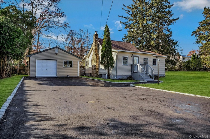 Modernized 2/3 Bedroom Cape With 2  Full Baths< Brand New Belgium Lined Large Driveway With A 2-Car Detached Garage