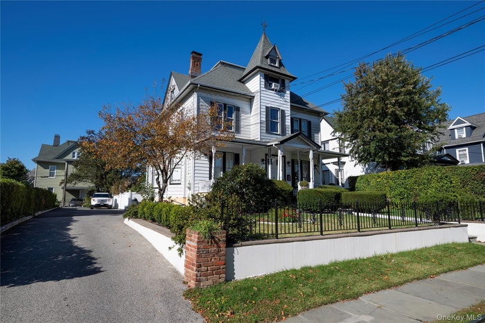 View of front of house with a porch and a fenced front yard
