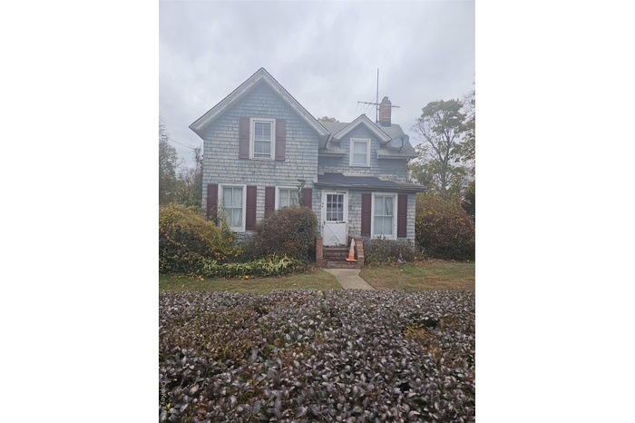 View of front of home with a chimney