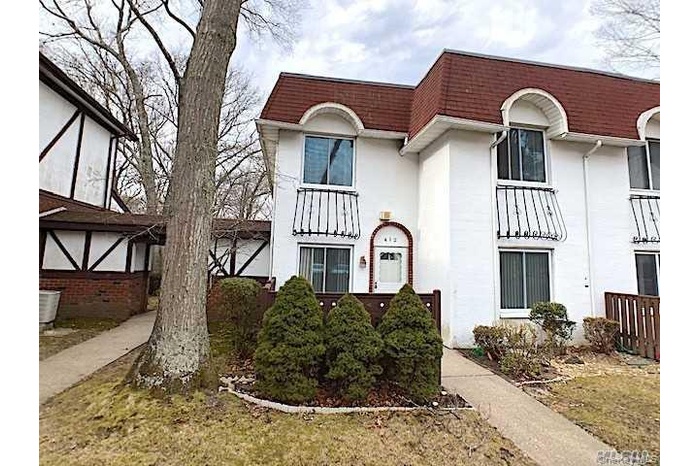 Front entrance. Patio behind trees