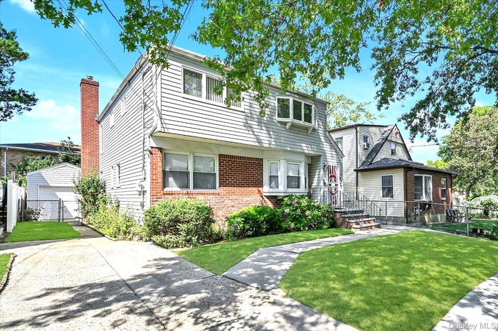 Colonial inspired home featuring brick siding