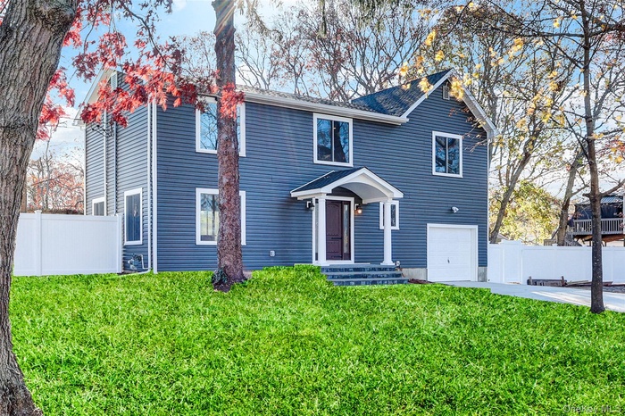 Traditional-style home with concrete driveway and a garage