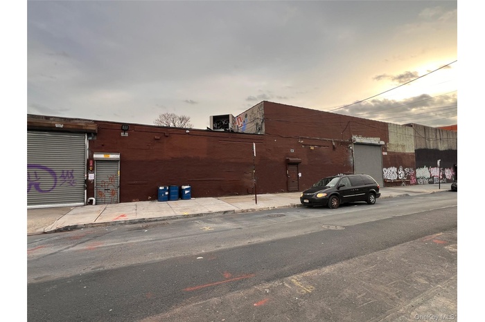 View of asphalt street featuring sidewalks and curbs