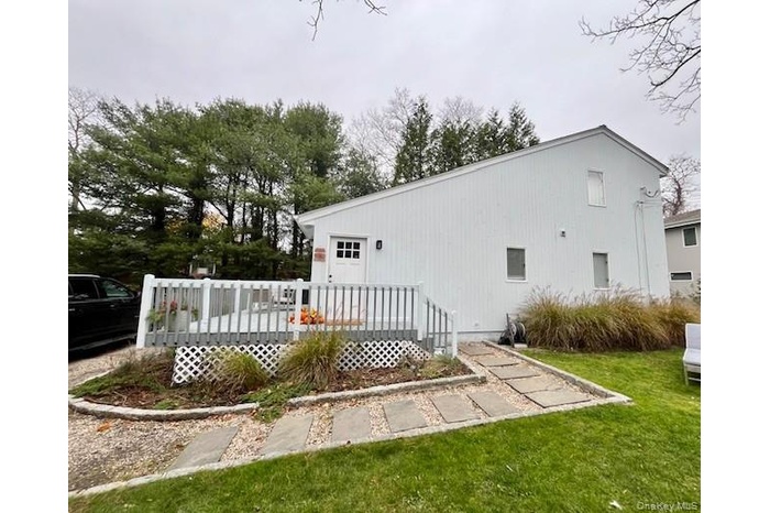 Back of property with a deck and a yard