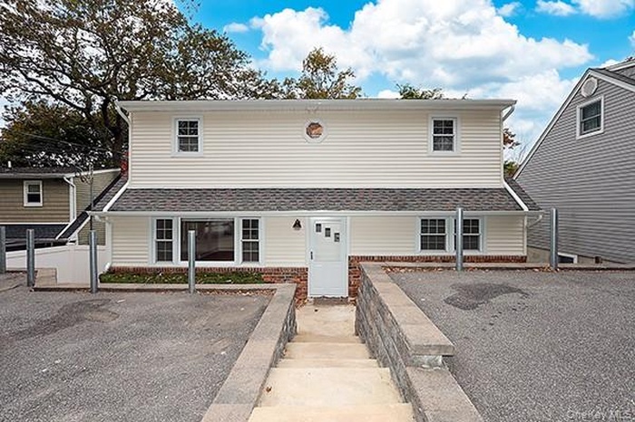 View of front of property featuring roof with shingles