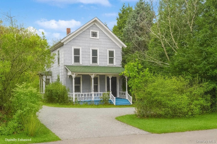 View of front of property with a porch and a chimney