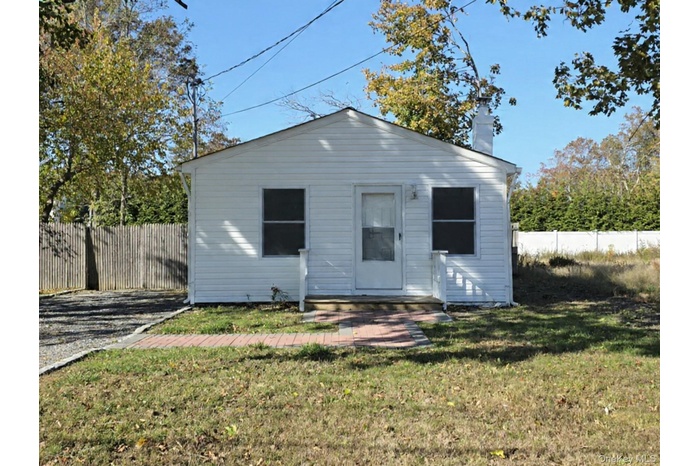 View of front of property featuring a chimney
