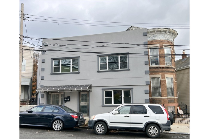 View of front facade with stucco siding and brick siding
