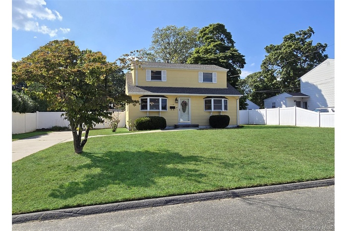 View of front of property featuring roof with shingles and driveway