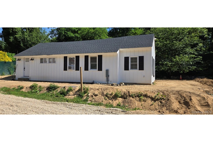 View of front of house featuring a shingled roof