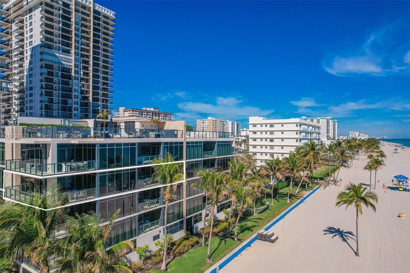 Direct beach access and panoramic ocean views throughout the unit.