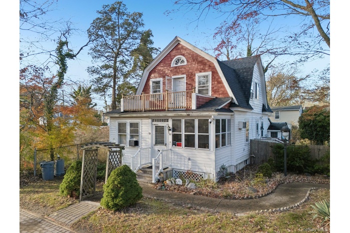 Dutch colonial with a gambrel roof and roof with shingles
