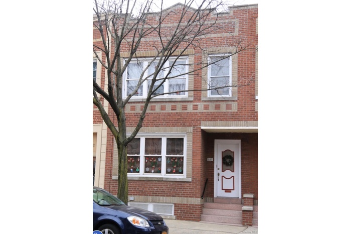 Traditional-style home with brick siding