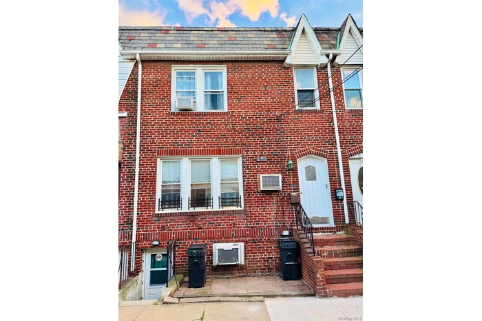 Traditional-style home featuring brick siding