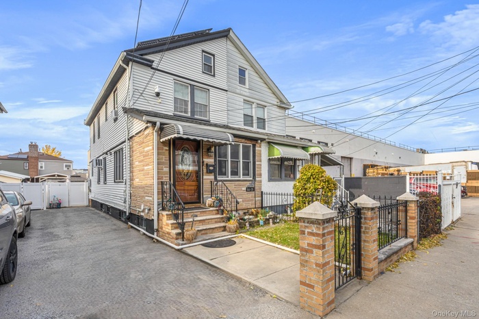 View of front of property with a gate and a fenced front yard