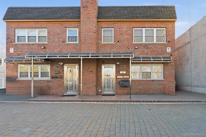 Back of property with brick siding and a chimney