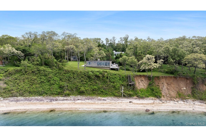 Aerial view of property and surrounding area with a nearby body of water