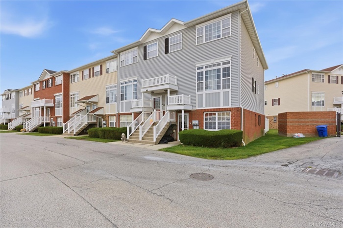View of front of home with a residential view and brick siding