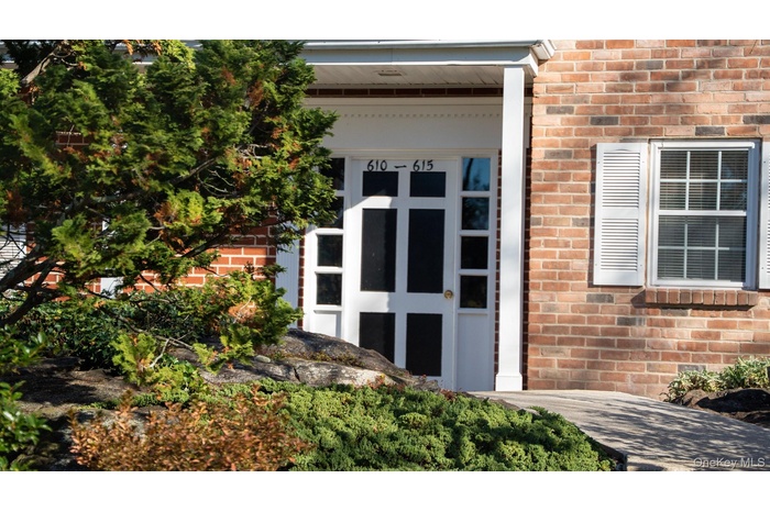 View of exterior entry with brick siding