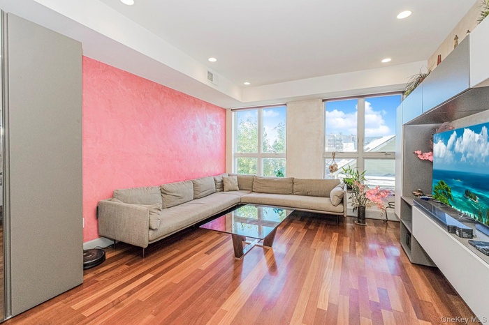 Living area with wood finished floors and recessed lighting