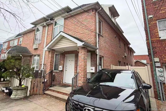 View of front of house with brick siding