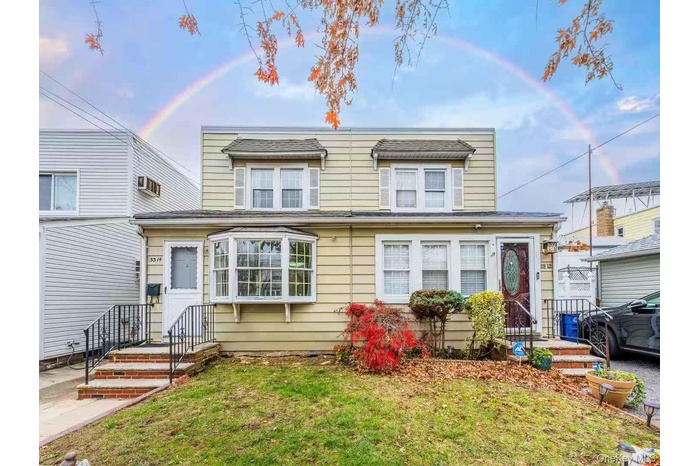 Traditional-style house featuring a front yard