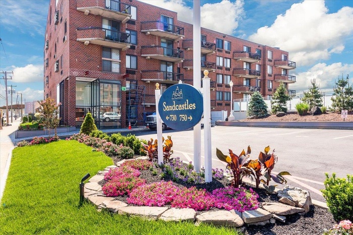 Community / neighborhood sign with a lawn