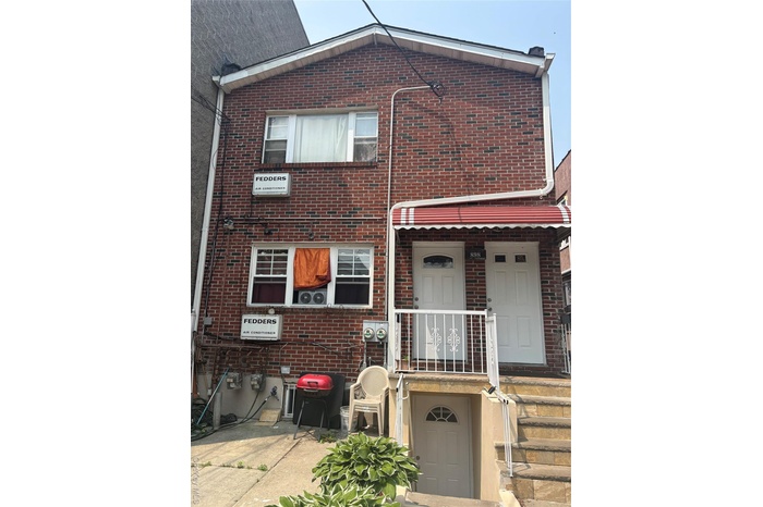 Traditional-style house with brick siding