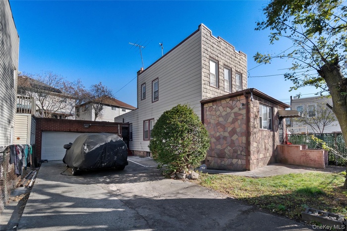 View of side of property featuring stone siding