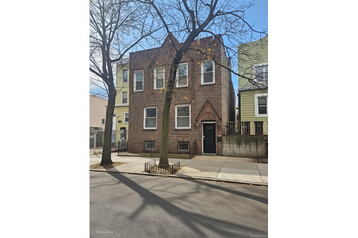 Traditional-style house with brick siding