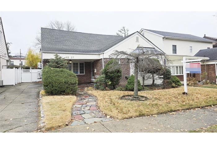 View of front facade with brick siding and roof with shingles