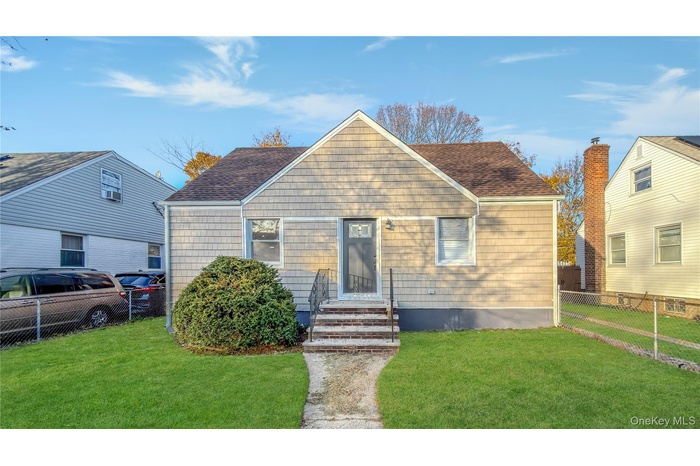 Bungalow featuring roof with shingles