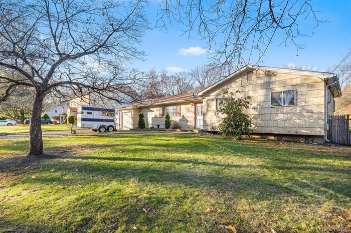 Single story home featuring a front lawn