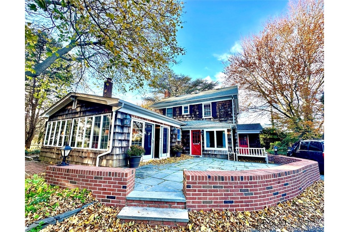 Rear view of property featuring a patio and a chimney
