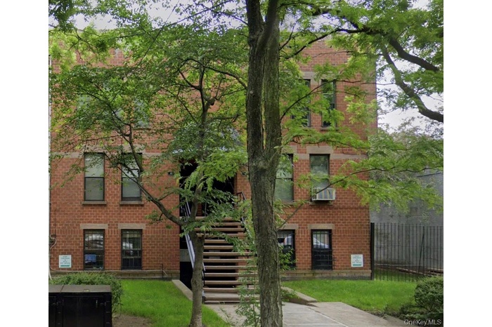 Exterior view of building façade and garden-level entrance.