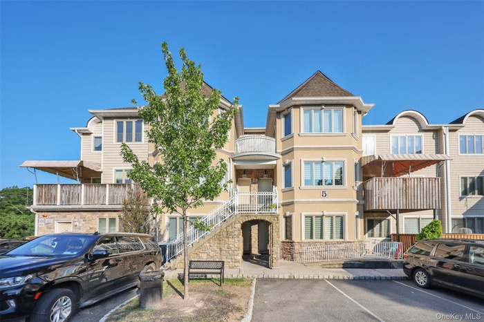 View of building exterior with uncovered parking