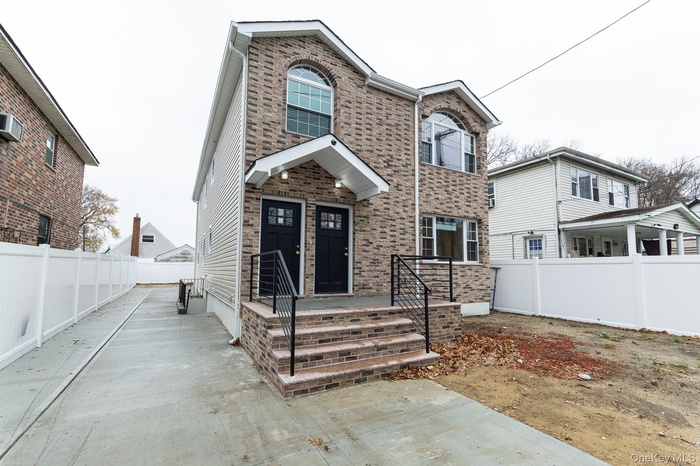 Traditional-style house featuring brick siding